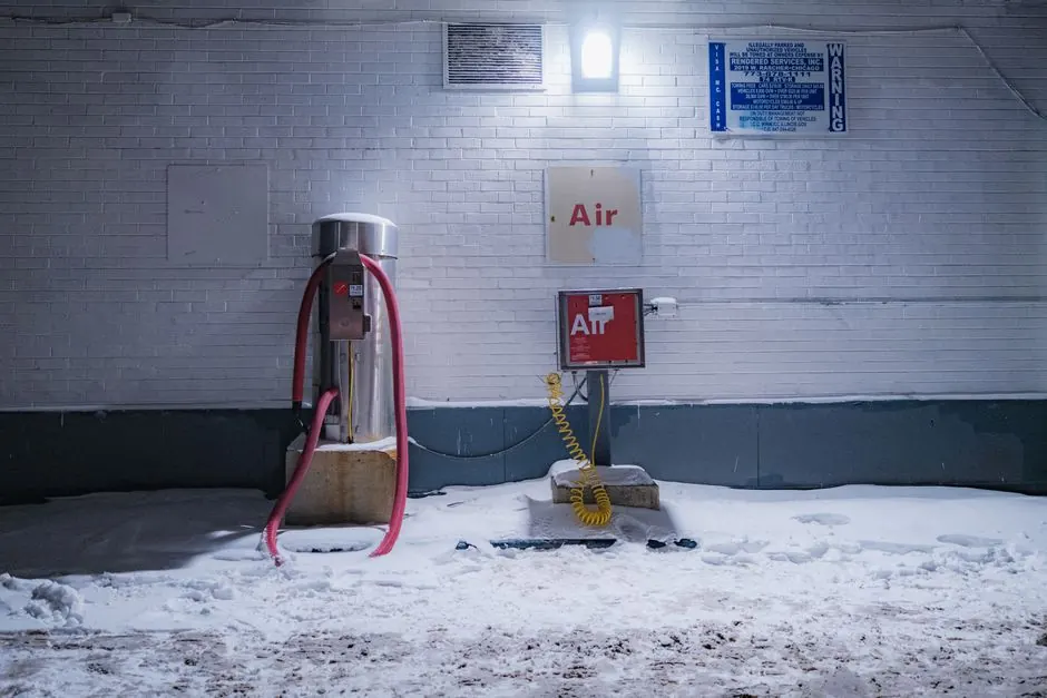 A snow-covered air pump station illuminated at night. Winter atmosphere captured outdoors.